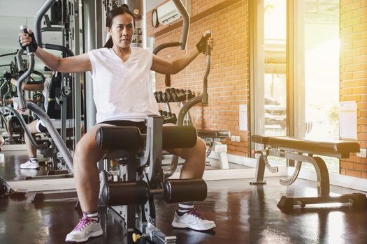 woman exercise workout on machine in gym.Concept of fitness.