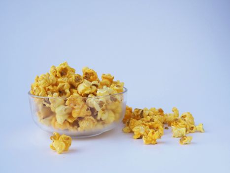 Popcorn in bowl on white background.