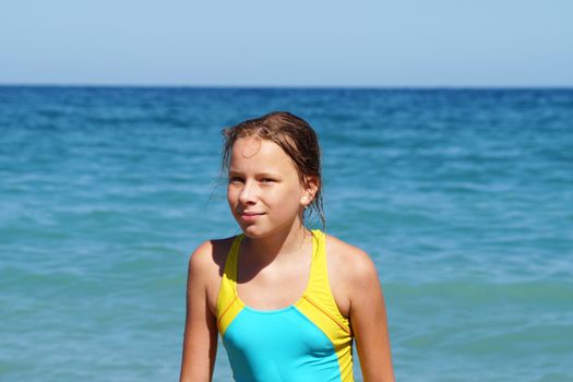 portrait of a girl in a swimsuit against the background of the sea horizon.