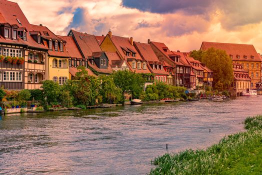 Bamberg city in Germany. River in foreground. Sunset cloudy sky and old houses in background