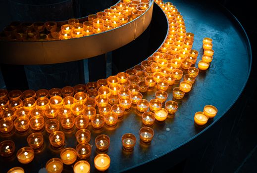 Candles in church of Wurzburg, Bavaria, Germany. Religion and christianity attributes