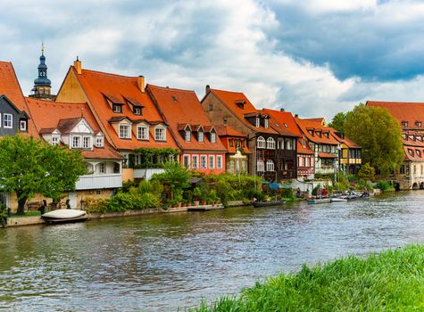 Bamberg city in Germany. River in foreground. Blue cloudy sky and old houses in background