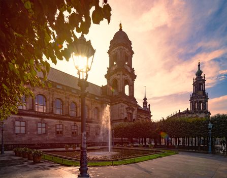 Katholische Hofkirche with Dresden Castle on the left. Travel and architecture in Europe. Sunset sky in background.