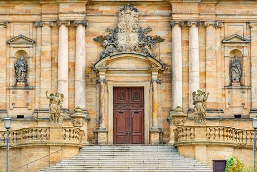 Grand doors of cathedral in Germany. Entrance in high arch with a lot of sculpture in it and statues on walls. Architecture of Europe.