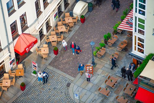 DRESDEN, GERMANY - SEPTEMBER 22, 2014: Top down view on street of Dresden, state of Saxony, Germany, Europe. Restaurant and people down below.