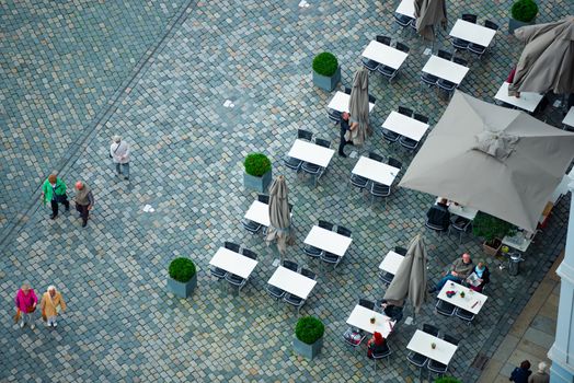 DRESDEN, GERMANY - SEPTEMBER 22, 2014: Top down view on street of Dresden, state of Saxony, Germany, Europe. Restaurant and people down below.