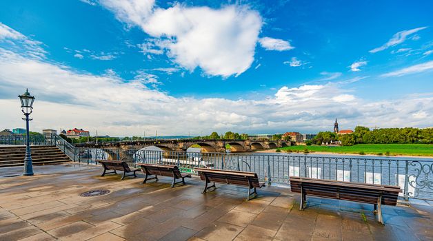 View from embankment on river Elbe in Dresden, Saxony, Germany, Europe. Blue cloudy sky in background.