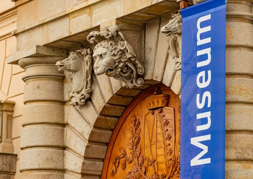 Old museum building in Dresden, Germany, Europe. Horse and lion heads above wooden door entrance.