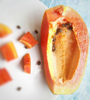 Orange color fresh papaya kept in white background with cut pieces and rich in fibre Vitamin C and antioxidants Boosts your immunity Good for diabetics and eyes