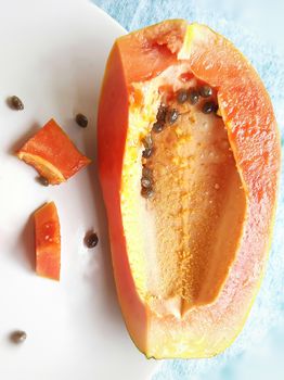 Orange color fresh papaya kept in white background with cut pieces and rich in fibre Vitamin C and antioxidants Boosts your immunity Good for diabetics and eyes