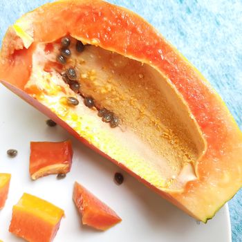 Orange color fresh papaya kept in white background with cut pieces and rich in fibre Vitamin C and antioxidants Boosts your immunity Good for diabetics and eyes