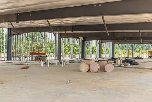 Horizontal shot of the inner view of a new commercial building that is under construction.