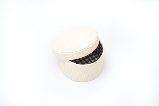 round gift box with ajar lid on a white insulated background