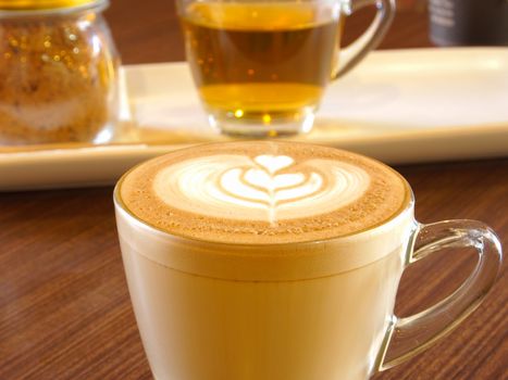 hot milk art coffee in cup in cafe