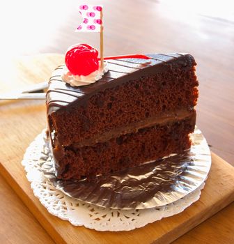 chocolate cake on wooden plate in cafe