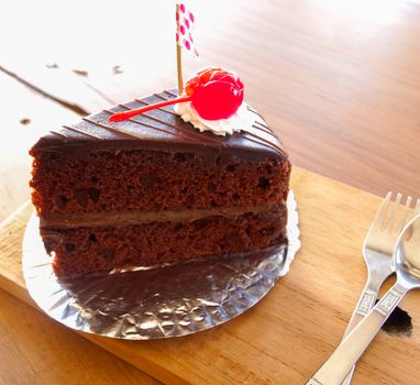 chocolate cake on wooden plate in cafe