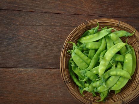 pea in basket on wooden table