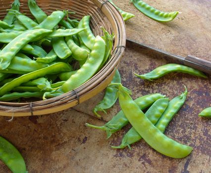 Peas on wooden cutting board to prepare the food.