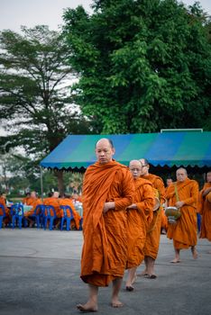 Bangkok, Thailand - January 1, 2020 : Unidentified thai monk ask for alms in morning for buddhist to make merit to offer food to the monks and receive blessing from the monks