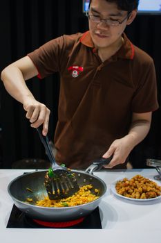 Bangkok, Thailand - May 29, 2016 : Unidentified chef cooking a food for show and sale to customers in the coffee and food exibition show event OTOP.
