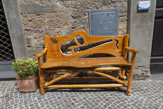 handmade wooden bench with light brown carved wood