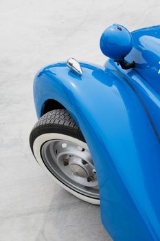 Blue old car fender and wheel.