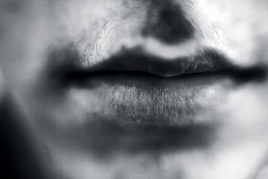 Close up of dried rough lips of a male teenager.