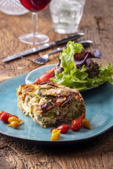 piece of french quiche with salad