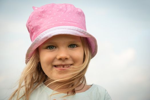 Girl child portrait. Little kid smiling face. Happy adorable and pretty young female head. Joy and happiness expression of caucasian child.  close-up of smile preschooler happy child with blond hair.
