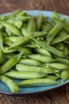 raw peas on dark wood