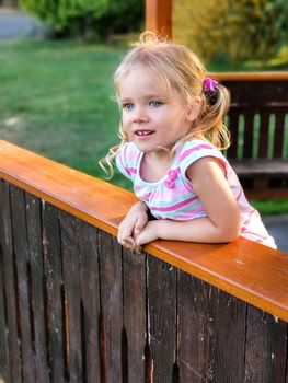 Adorable girl child looks straight ahead with curiosity. Portrait of young caucasian female child. Kid face with pretty eyes and look full of emotion. Enjoyment expression. Blonde with lovely face.