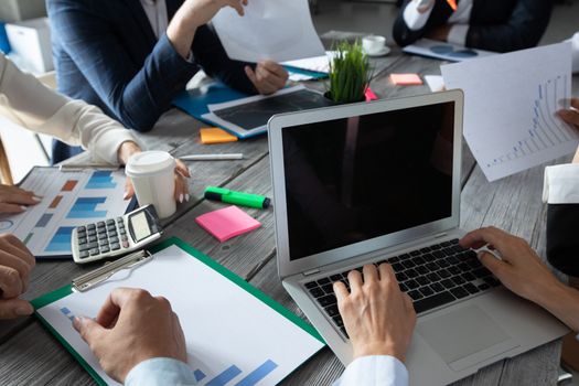 Business corporate management planning team concept, people sitting around office table and working with financial data reports