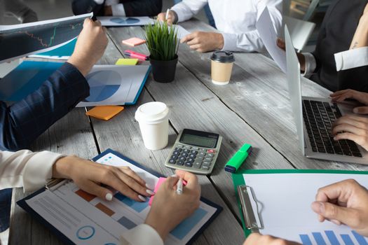 Business corporate management planning team concept, people sitting around office table and working with financial data reports