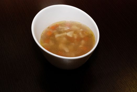 vegetable soup served in the white bowl. side view
