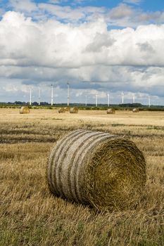 Wind turbines, hay bales and agriculture in northern Germany.