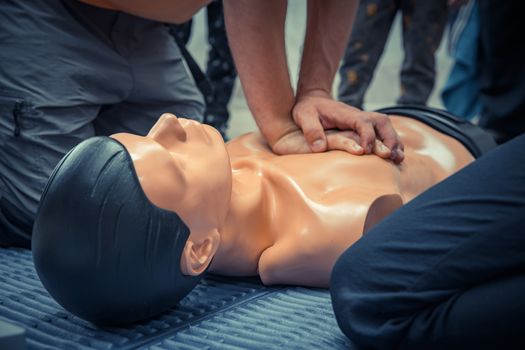 first aid training with silicone dummy, heart massage