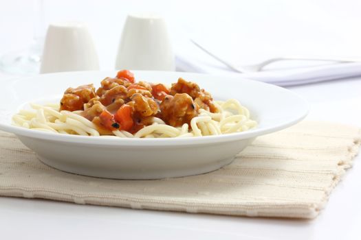 spaghetti with tomato sauce in white background