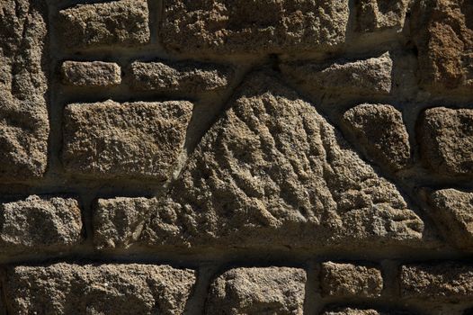 Dark brown close-up stone wall detail.