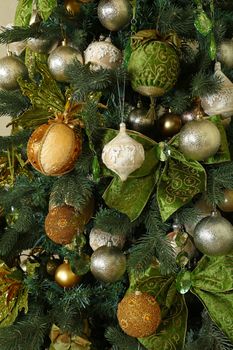 Close up handmade decorations hanging Christmas tree, bows, balls, spheres, front view