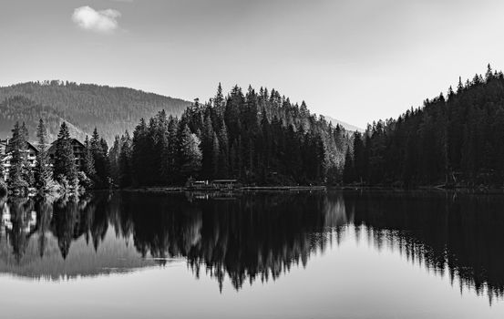 Black and white image of Lake Braies and its reflections, Italian landscape in South Tyrol