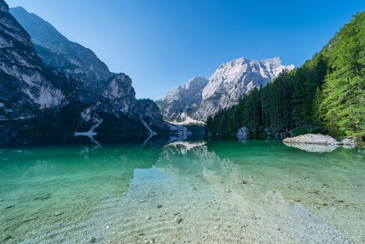 The Seekofel mountain reflected in the clear waters of Lake Braies, Italian landscape in South Tyrol