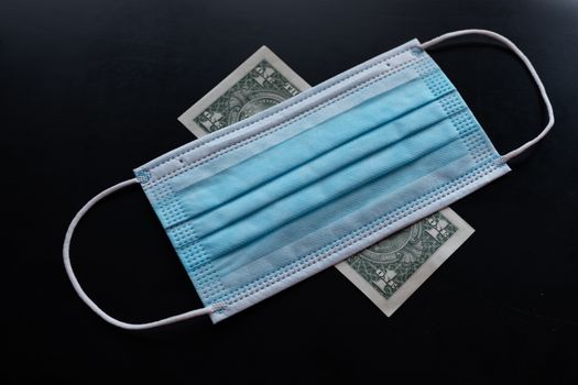 Cost of prevention corona virus - money and preventive facemask stock photo