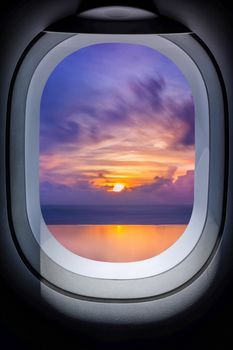 Beautiful sunset in seascape from aircraft window