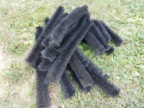 black pipe cleaner for gutters in green grass or lawn