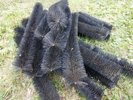 black pipe cleaner for gutters in green grass or lawn