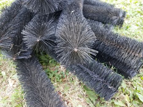 black pipe cleaner for gutters in green grass or lawn