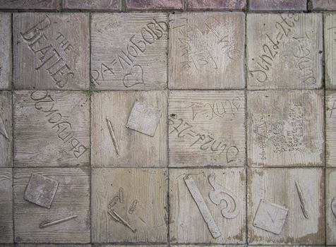 Ukraine, Sevastopol-13.06.2013: paving slabs with a creative drawing of words in different languages and objects                            
