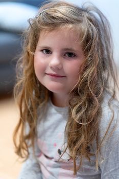 Portrait of a cute little Caucasian girl child with disheveled hair.