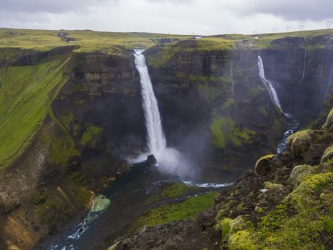 Valley of river Fossa with Beautiful Haifoss waterfall in South Iceland, summer moody sky.