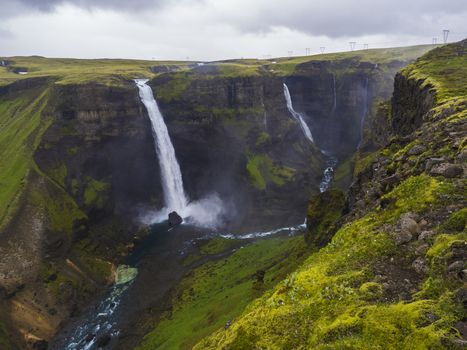 Valley of river Fossa with Beautiful Haifoss waterfall in South Iceland, summer moody sky.